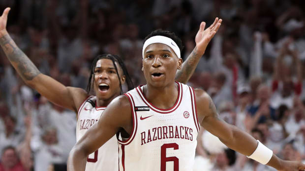 Arkansas guard Layden Blocker begins to celebrate the Arkansas Razorbacks' upset over Duke in the SEC-ACC Challenge.